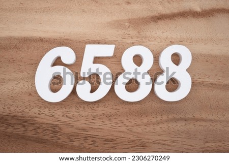White number 6588 on a brown and light brown wooden background.