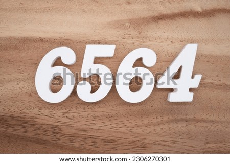 White number 6564 on a brown and light brown wooden background.
