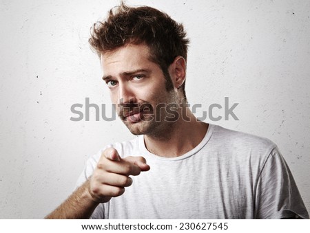 Young mustached man pointing towards the camera Royalty-Free Stock Photo #230627545