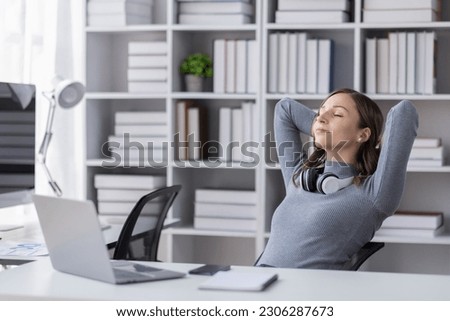 Business woman in office relaxing in chair