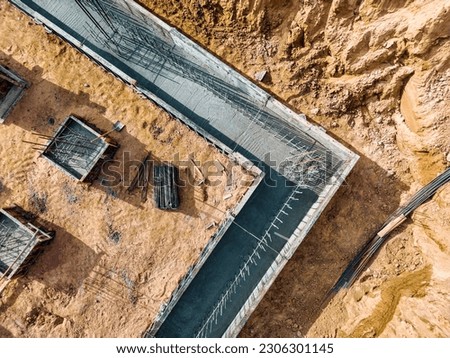 Monolithic reinforced concrete foundations or grillages for the construction of a large modern residential building. Rostverk at the construction site. Foundation for the building. View from above Royalty-Free Stock Photo #2306301145