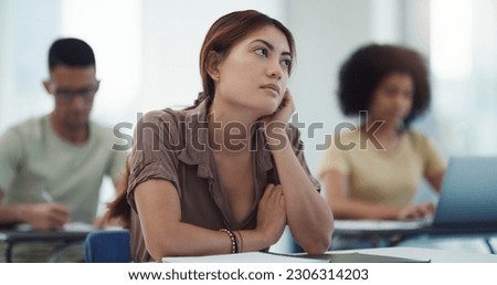 Education, depression and girl university student in a classroom bored, adhd or daydreaming during lecture. Thinking, anxiety and female learner distracted in class, contemplation, boredom or sad Royalty-Free Stock Photo #2306314203