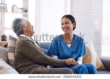 Consulting, caregiver and elderly woman laughing on sofa and holding hands in home living room. Support or healthcare, happy and female nurse talking or communication with senior citizen on a couch
