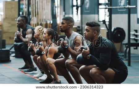 Weightlifting, fitness and people with kettle bell in gym for training, exercise and workout class. Teamwork, body builder and men and women squat with weights for challenge, wellness and strength Royalty-Free Stock Photo #2306314323