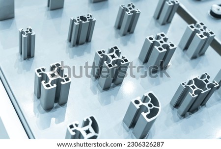 Cross sections of extruded aluminium or aluminum channels for use in manufacturing and fabrication Royalty-Free Stock Photo #2306326287
