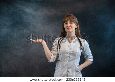 beautiful  doctor in white uniform medical lab coat showing with hand and pointing with finger. Medical personal, healthcare