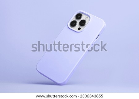 iPhone 14 Pro max starlight in very peri color soft silicone case falls down back view, phone case mockup in monochrome colours isolated on purple background