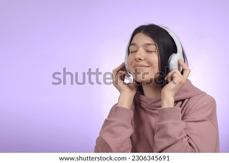 cute brunette woman enjoying music in headphones