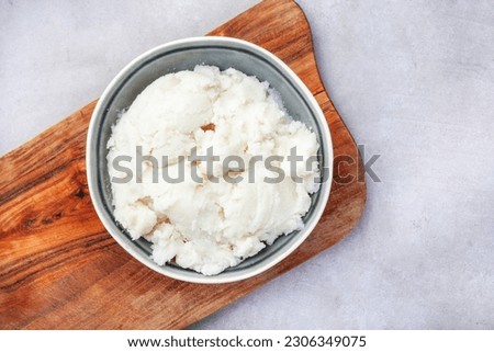 Traditional South African pap or maize meal on wood and mottled grey  Royalty-Free Stock Photo #2306349075