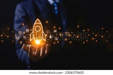 The hand shows a rocket and an icon. Concept of Startup Business, Entrepreneurship Idea, and Online Digital Business. network connection on the interface Marketing, Technology, and Success Royalty-Free Stock Photo #2306370605