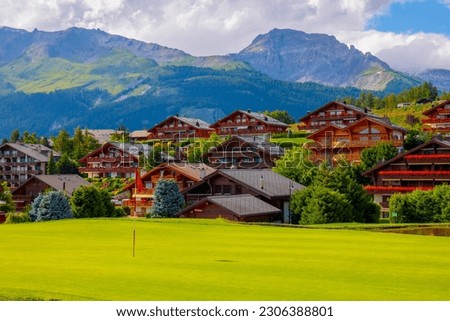 Golf Course with House and Mountain View in Crans Montana in Valais, Switzerland. Royalty-Free Stock Photo #2306388801