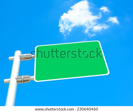 Blank green road sign board  on blue sky background - looking up view