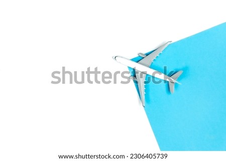 Airplane model on a blue and white background, top view.