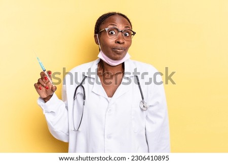 shrugging, feeling confused and uncertain, doubting with arms crossed and puzzled look. physician and syringe concept