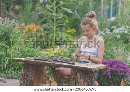adorable blond girl sitting in the garden and creating lavender framed images