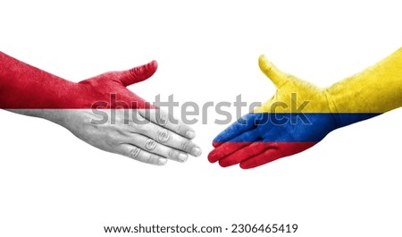 Handshake between Colombia and Monaco flags painted on hands, isolated transparent image.