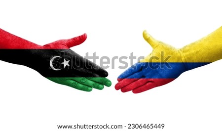 Handshake between Colombia and Libya flags painted on hands, isolated transparent image.