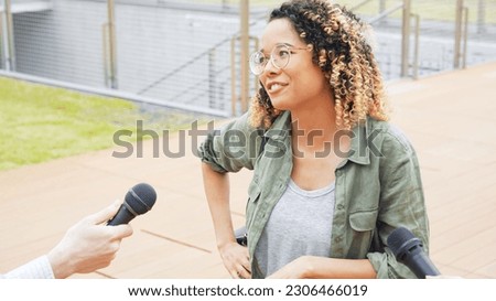 African woman being interviewed on the street by the media. Royalty-Free Stock Photo #2306466019