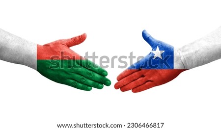 Handshake between Chile and Madagascar flags painted on hands, isolated transparent image.