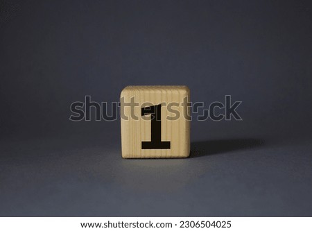Number one symbol. Number 1 on wooden cubes. Beautiful grey background. Business and Number one concept. Copy space.