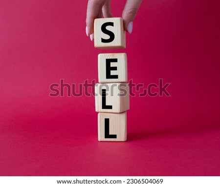 Sell symbol. Concept word Sell on wooden cubes. Businessman hand. Beautiful red background. Business and Sell concept. Copy space.