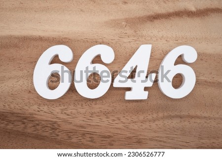 White number 6646 on a brown and light brown wooden background.
