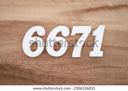 White number 6671 on a brown and light brown wooden background.