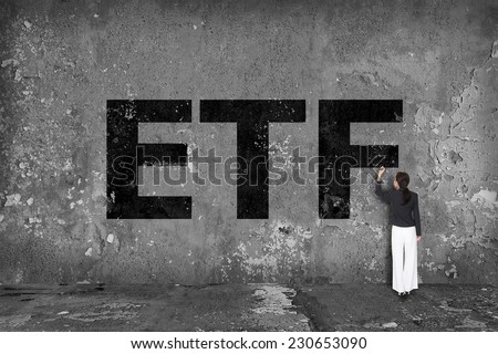businesswoman drawing ETF on the wall