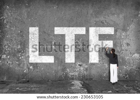 businesswoman drawing LTF on the wall