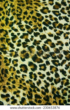 Leopard leather pattern texture closeup background.