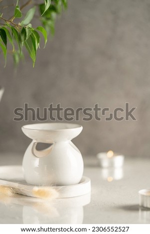 Ceramic Candle Aroma oil lamp with essential oil bottle. Scented lamps.Atmosphere of meditation Royalty-Free Stock Photo #2306552527