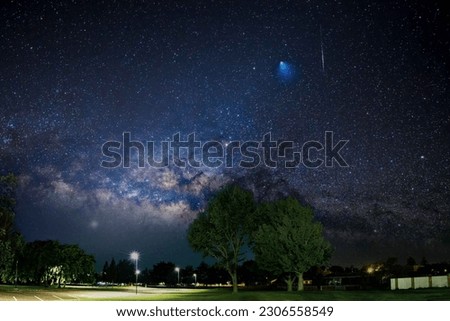 panorama of the night starry sky with the milky way and a flying comet