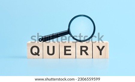 wooden cubes with the text: query and magnifying glass, blue background. business concept