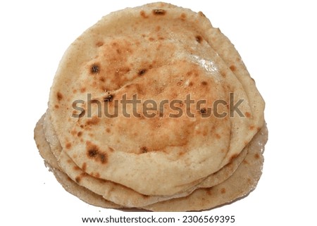 Traditional Egyptian flat bread with wheat bran and flour, regular Aish Baladi or Egypt bread baked in extremely hot ovens, it is the result of a mixture of wheat flour, yeast, salt and water Royalty-Free Stock Photo #2306569395