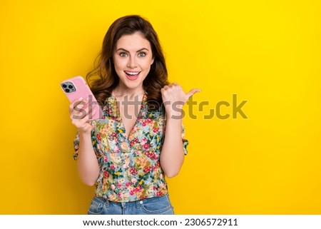 Photo of funky funny lady using device pointing finger demonstrate eshop discounts empty space isolated shine color background