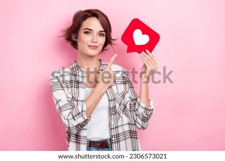 Photo of sweet shiny lady wear checkered jacket pointing finger heart like card isolated pink color background