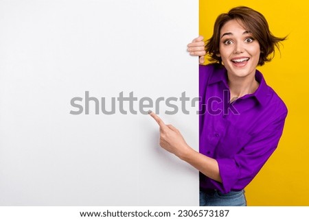 Portrait of cheerful person direct finger empty space billboard proposition isolated on yellow color background
