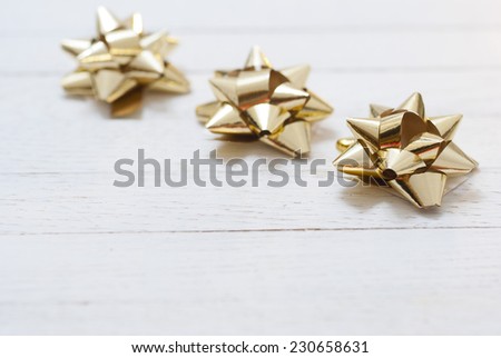 gift bows on white wooden surface