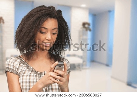 Young happy woman holding smartphone