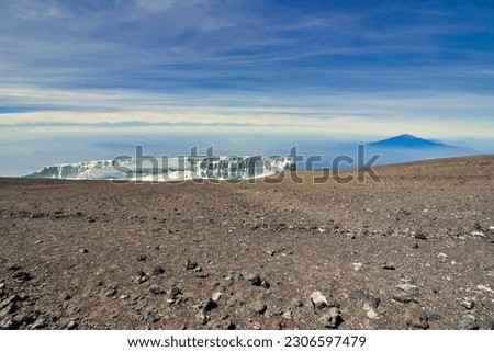 Rebmann glacier with backdrop of Mount Meru in the early morning light viewed from Kibo crater rim on Kilimanjaro, Tanzania Royalty-Free Stock Photo #2306597479