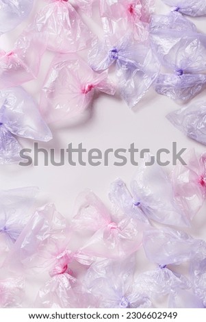 Plastic free environment protection concept. Empty used plastic bags,  frame background, copy space. Aesthetic top view many colored disposable transparent polyethylene packet. Plastic bag free day