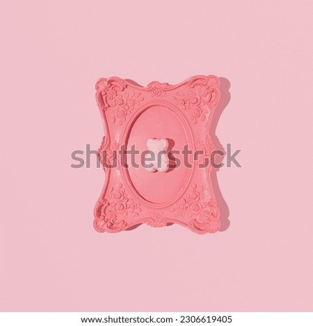 Gummy bear framed in a vintage romantic wall frame, creative aesthetic layout, candy pink background. Retro girly style. 