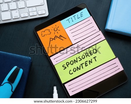 Tablet with sponsored content as part of site. Digital marketing concept. Royalty-Free Stock Photo #2306627299