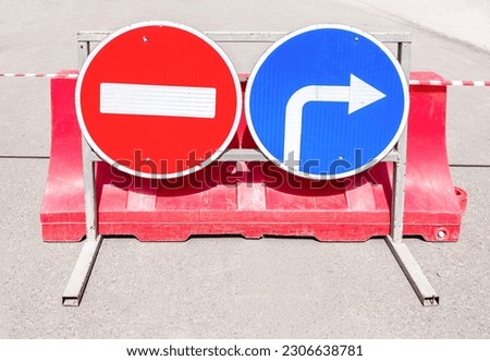 Road signs No passage, Direction of traffic on a city street in summer. Roadway closed. Block traffic for transport
