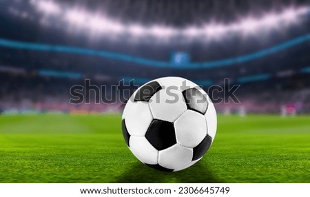 Official Football Ball at stadium on green grass Royalty-Free Stock Photo #2306645749