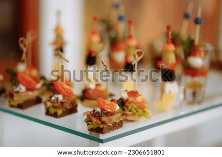 Assortment of elegant and delicious canapes. Bite-sized snacks, stylish and savory little sandwiches. Royalty-Free Stock Photo #2306651801