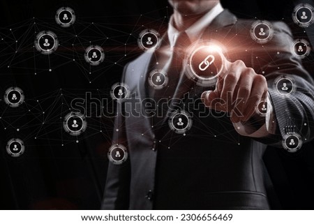 A man clicks the link icon in the network connecting users on a black background.