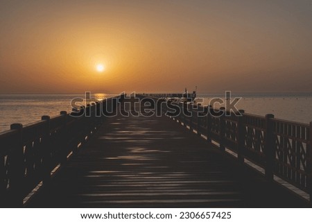 A beautiful sunset in the morning, over the sea, with a yellow sun in Hurgada, Egypt, beautifull view in a beach full of palms