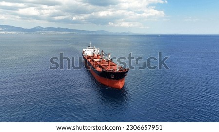 Aerial drone photo of huge bulk carrier tanker anchored in deep blue Aegean sea Royalty-Free Stock Photo #2306657951