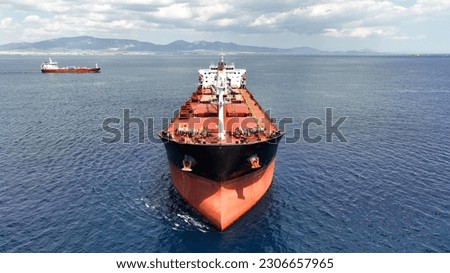 Aerial drone photo of huge bulk carrier tanker anchored in deep blue Aegean sea